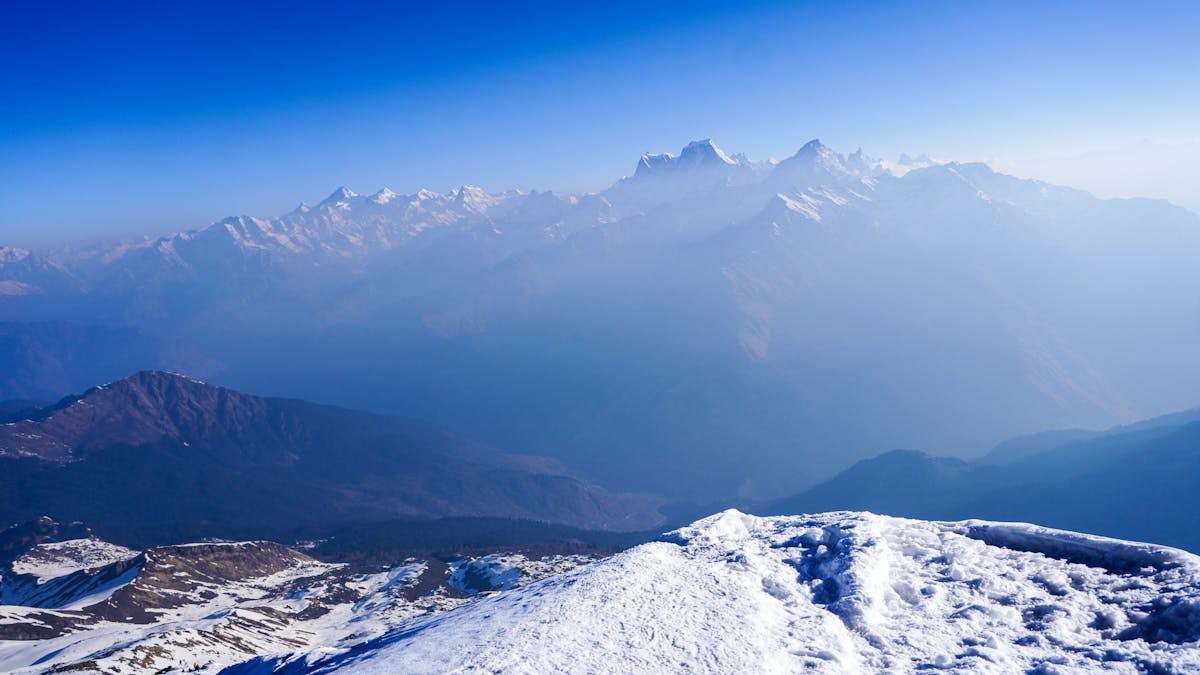 Breathtaking view of snow-covered Himalayan mountains in Salud Dugra, Uttarakhand, India.